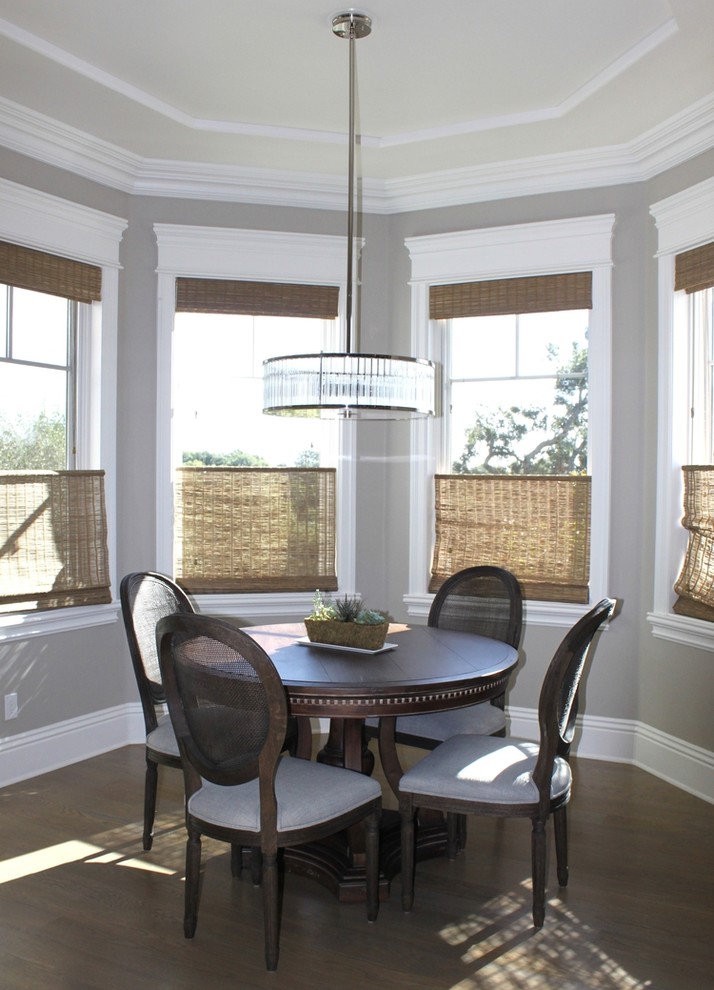 Small traditional dining room with grey walls, medium hardwood floors, no fireplace and brown floor.