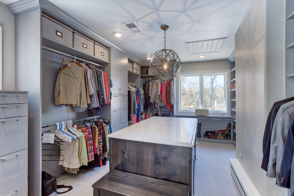 This is an example of an expansive beach style gender-neutral dressing room in Denver with louvered cabinets, medium wood cabinets and ceramic floors.