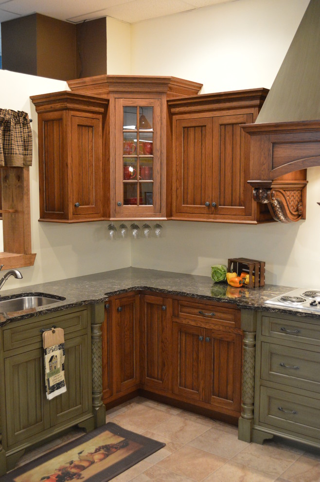 Example of a large mountain style l-shaped ceramic tile and beige floor enclosed kitchen design in Philadelphia with a double-bowl sink, recessed-panel cabinets, dark wood cabinets, granite countertops and stainless steel appliances