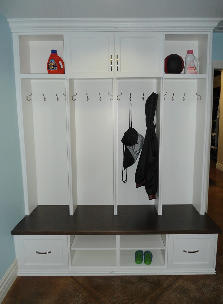 Inspiration for a large transitional single-wall concrete floor entryway remodel with shaker cabinets, black cabinets, wood countertops and blue walls
