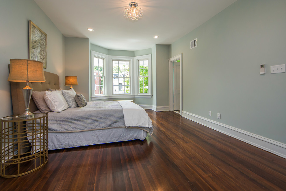 This is an example of a large transitional master bedroom in Richmond with grey walls, dark hardwood floors and brown floor.
