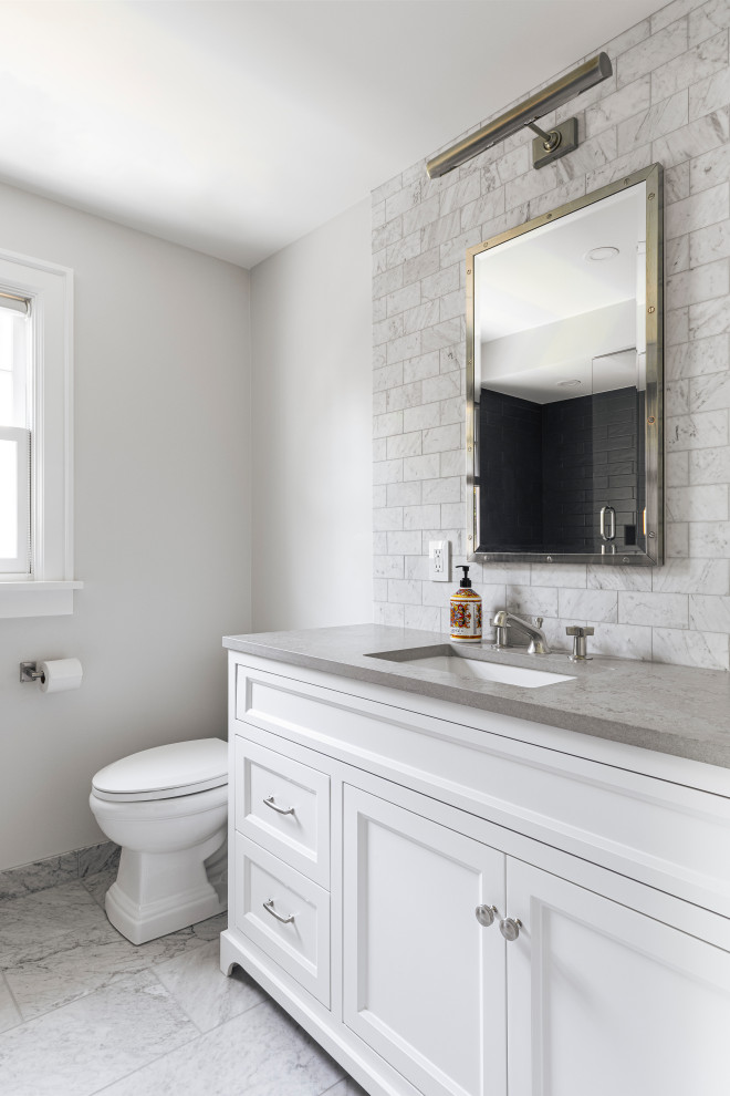 Photo of a mid-sized bathroom in Portland with white cabinets, a shower/bathtub combo, white tile, white walls, marble floors, white floor, a shower curtain, grey benchtops, a single vanity and a built-in vanity.