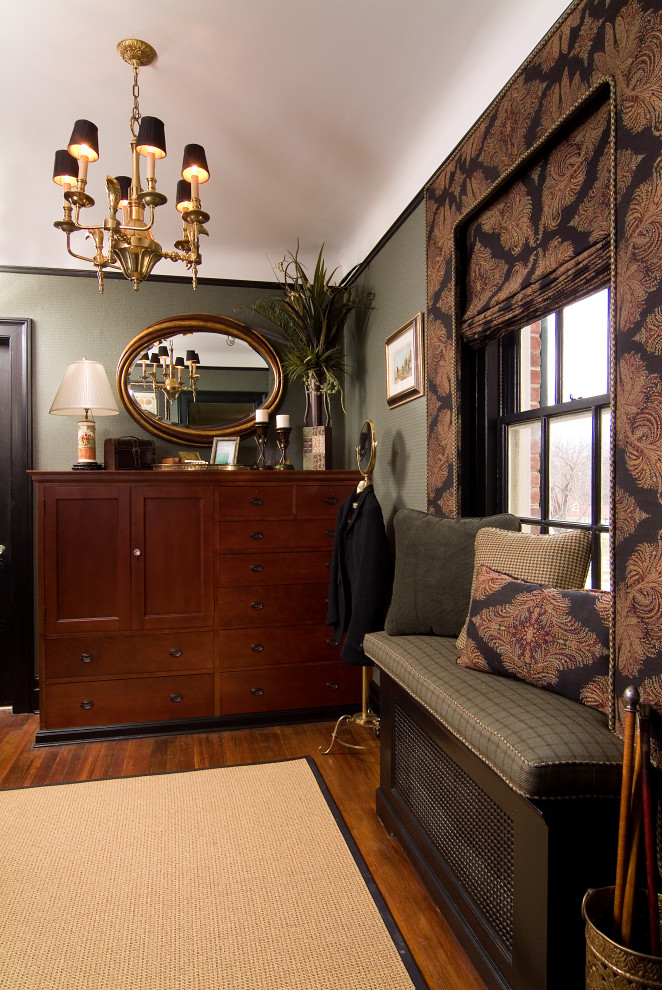 Inspiration for a mid-sized traditional men's dressing room in Newark with recessed-panel cabinets, medium wood cabinets, medium hardwood floors and brown floor.