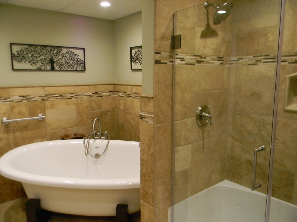This is an example of a mid-sized modern master bathroom in DC Metro with furniture-like cabinets, dark wood cabinets, a freestanding tub, beige tile, stone tile, beige walls and travertine floors.