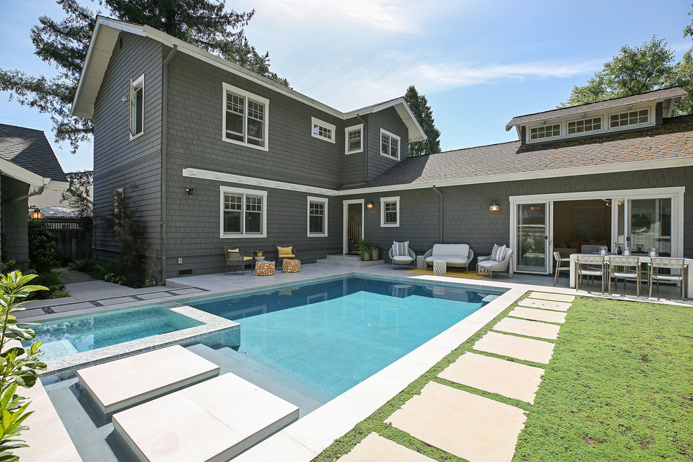 Example of a transitional concrete paver and rectangular hot tub design