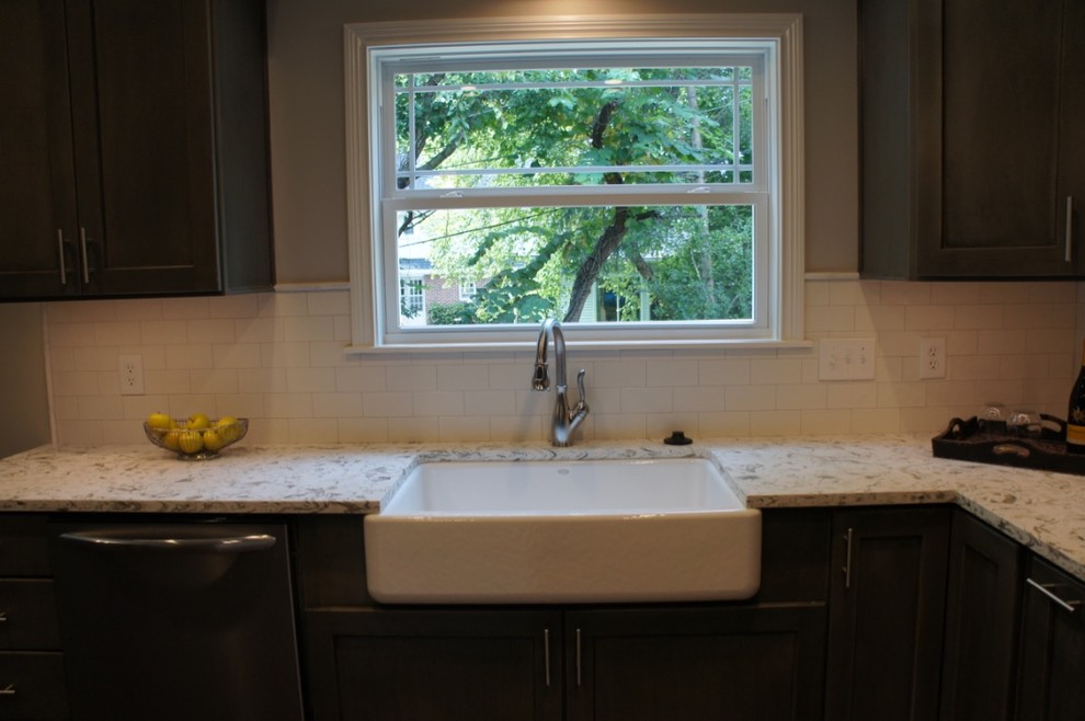 Eat-in kitchen - transitional u-shaped eat-in kitchen idea with flat-panel cabinets, white backsplash, stainless steel appliances and an island
