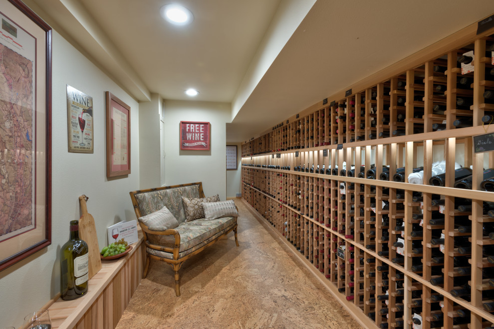 Large transitional wine cellar in Seattle with cork floors and storage racks.