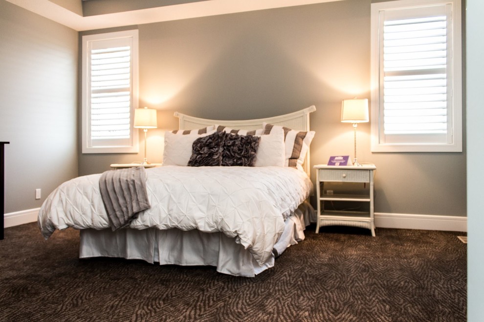 This is an example of a mid-sized traditional master bedroom in Calgary with grey walls, carpet and no fireplace.