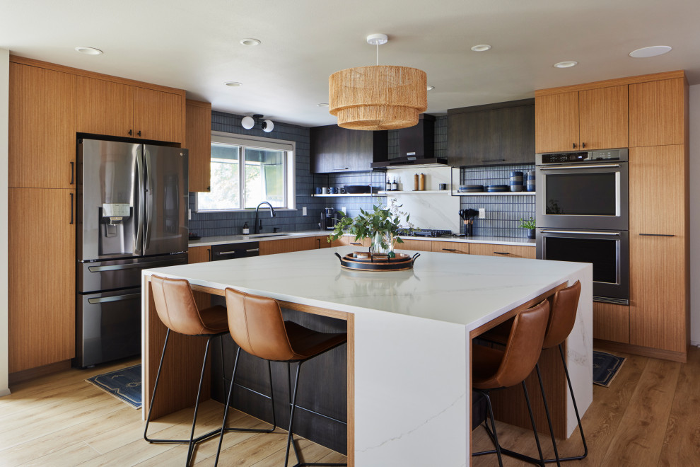 Inspiration for a large 1950s l-shaped vinyl floor kitchen remodel in Seattle with an undermount sink, flat-panel cabinets, quartz countertops, blue backsplash, porcelain backsplash, stainless steel appliances, an island and white countertops