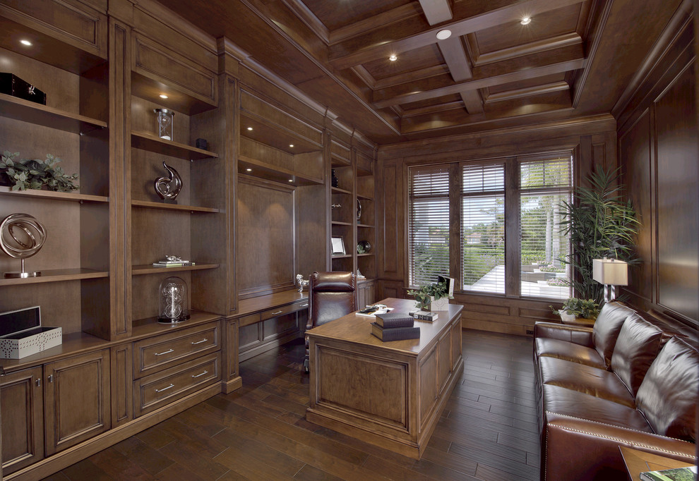 Photo of a transitional home office in Miami with dark hardwood floors and a freestanding desk.