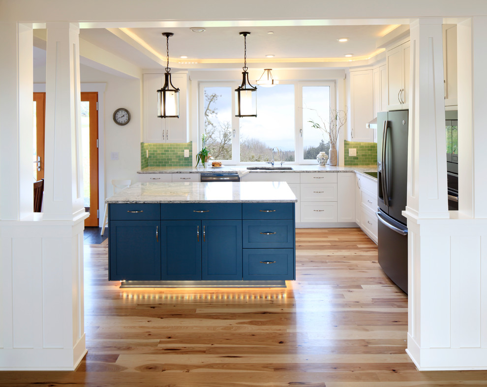 Example of a mid-sized transitional u-shaped medium tone wood floor and beige floor eat-in kitchen design with an undermount sink, shaker cabinets, white cabinets, quartz countertops, green backsplash, subway tile backsplash, stainless steel appliances, an island and multicolored countertops