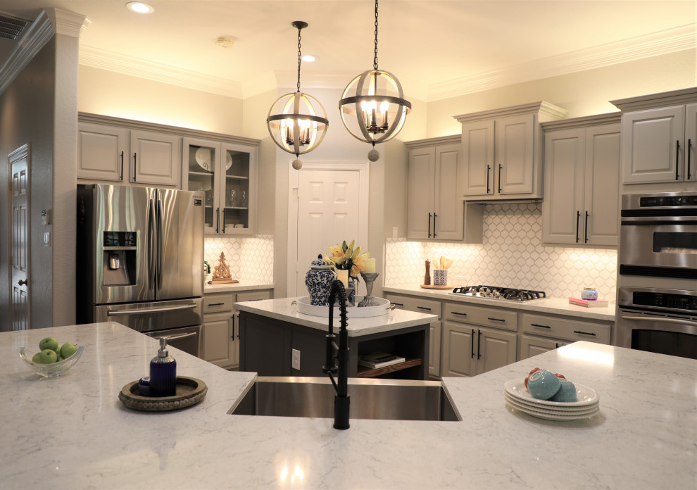 Inspiration for a large kitchen pantry in Houston with a farmhouse sink, grey cabinets, quartzite benchtops, white splashback, mosaic tile splashback, stainless steel appliances, porcelain floors, with island, beige floor and grey benchtop.