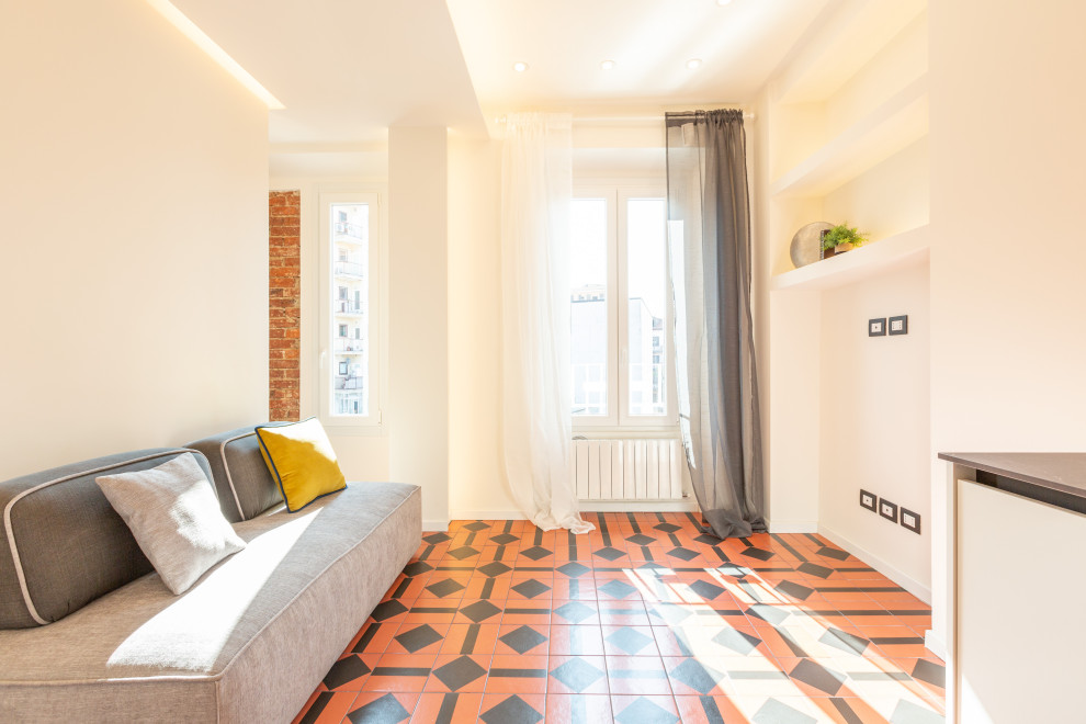 Стильный дизайн: маленькая открытая гостиная комната в стиле ретро с бежевыми стенами, полом из керамической плитки, многоуровневым потолком и кирпичными стенами для на участке и в саду - последний тренд