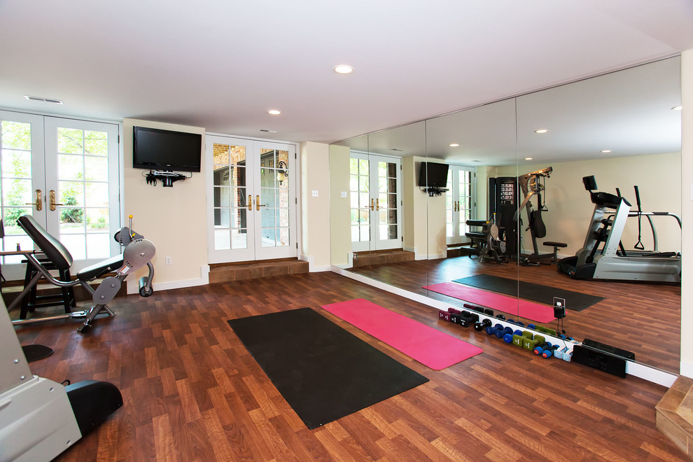Design ideas for a mid-sized traditional multipurpose gym in St Louis with white walls and dark hardwood floors.