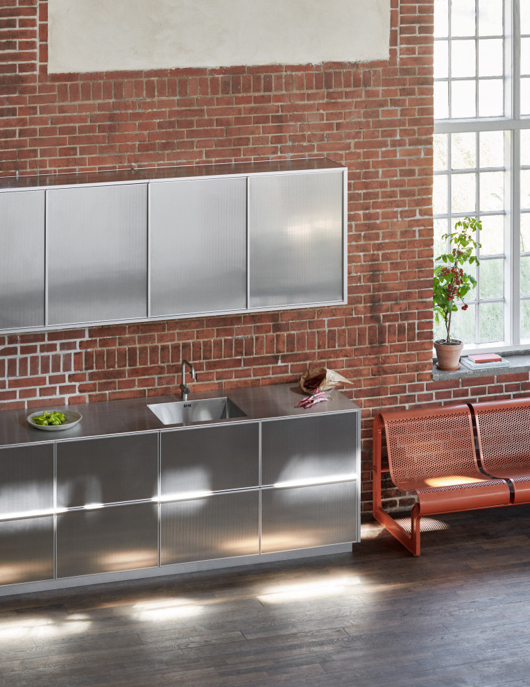 Photo of an industrial single-wall kitchen in Copenhagen with grey cabinets, stainless steel benchtops and grey benchtop.