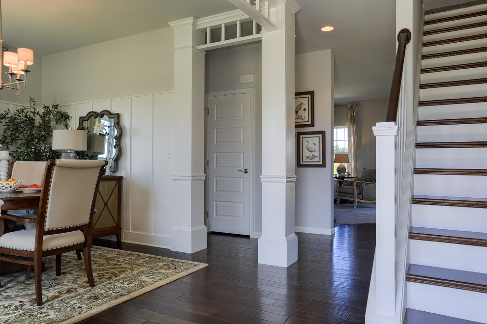Photo of a mid-sized transitional foyer in Other with beige walls and dark hardwood floors.