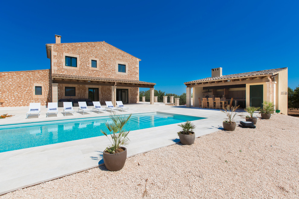 Photo of a mid-sized country rectangular lap pool in Palma de Mallorca with a pool house.