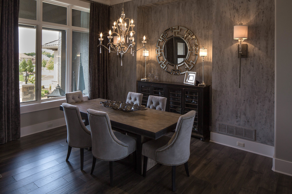 Photo of a large transitional open plan dining in Kansas City with light hardwood floors, a standard fireplace, a wood fireplace surround and grey walls.