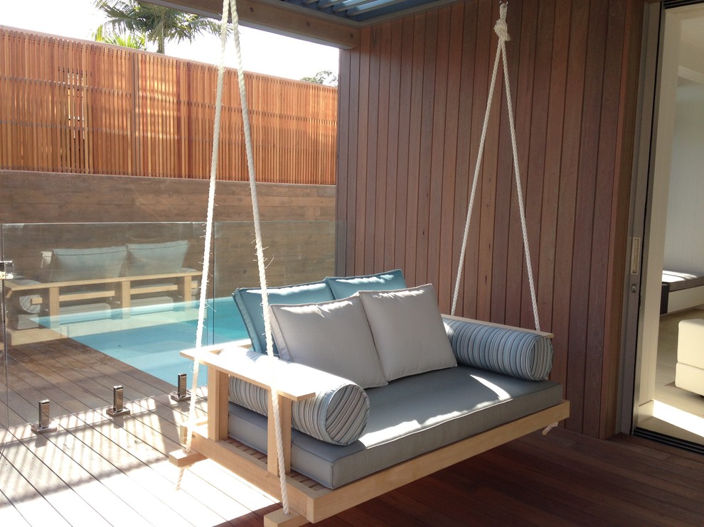 This is an example of a beach style courtyard patio in Sunshine Coast with a pergola.
