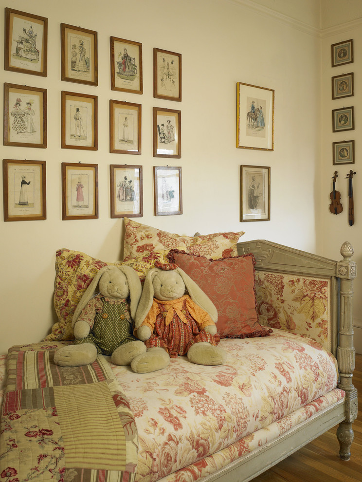 This is an example of an eclectic kids' bedroom for kids 4-10 years old and girls in San Francisco with beige walls and medium hardwood floors.