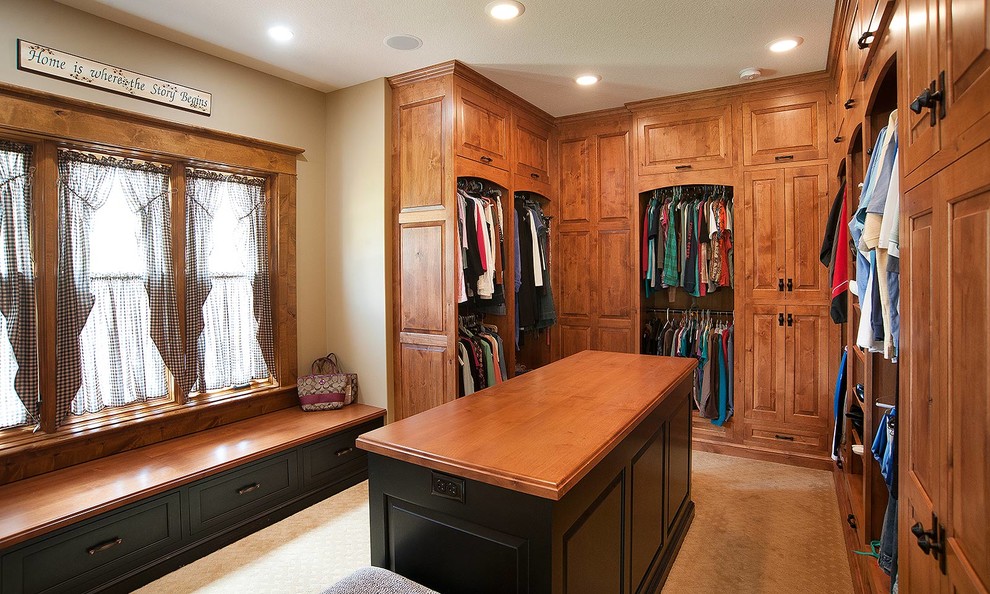 Design ideas for a country storage and wardrobe in Cleveland with medium wood cabinets.