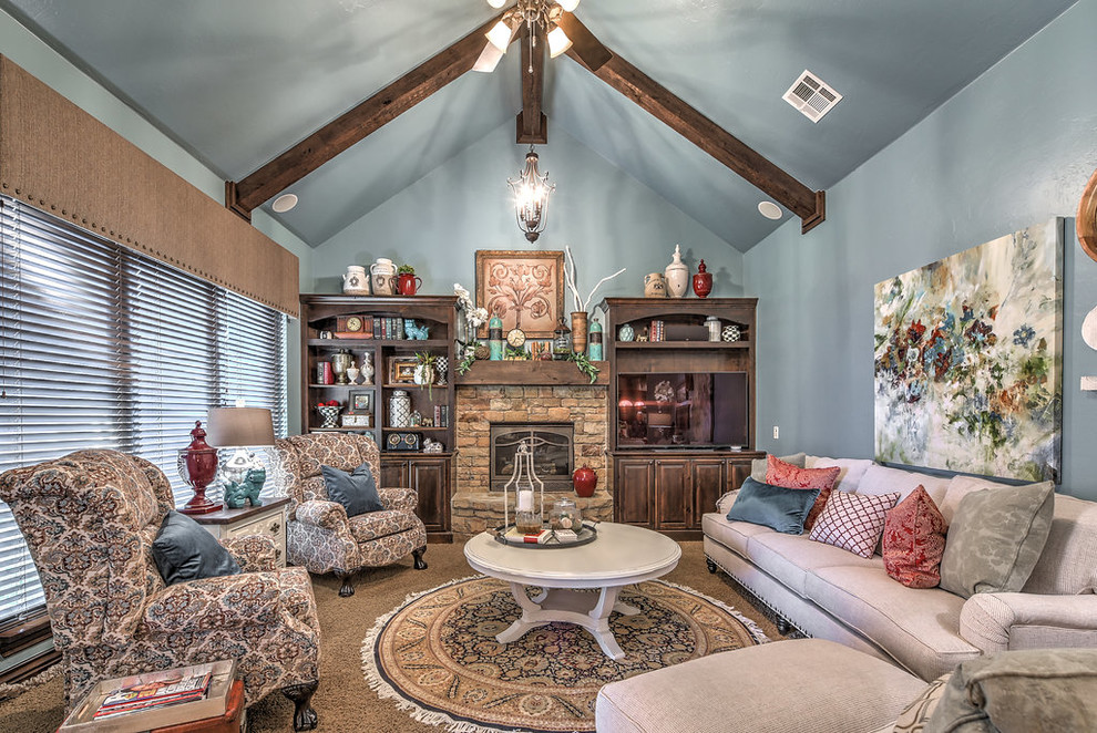 Inspiration for a mid-sized traditional open concept family room in Oklahoma City with blue walls, carpet, a standard fireplace, a stone fireplace surround, a wall-mounted tv and beige floor.