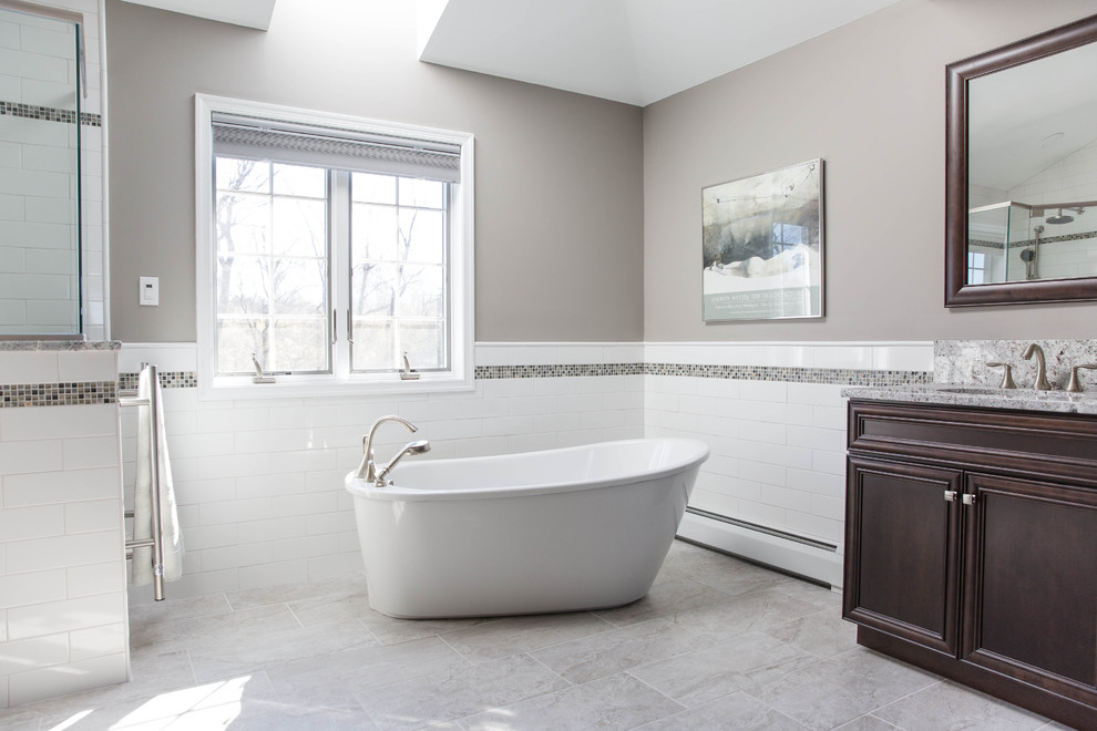 Example of a large transitional master freestanding bathtub design in Philadelphia