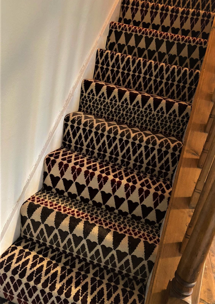 Design ideas for a medium sized contemporary carpeted straight wood railing staircase in Hertfordshire with carpeted risers.