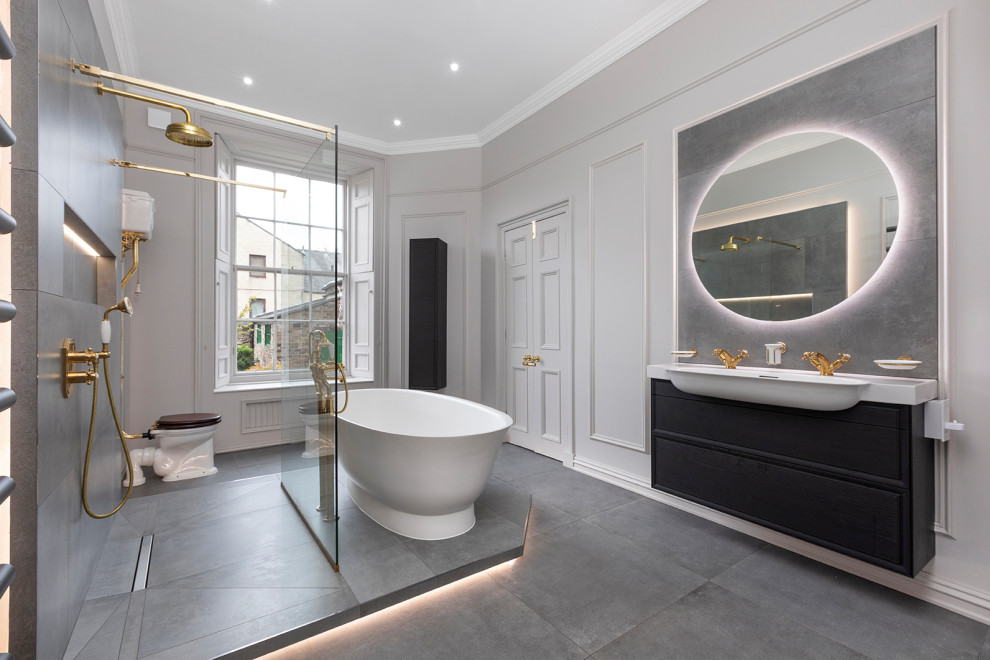 Inspiration for a large classic grey and white family bathroom in Edinburgh with flat-panel cabinets, black cabinets, a freestanding bath, a walk-in shower, a two-piece toilet, grey tiles, porcelain tiles, white walls, porcelain flooring, grey floors, an open shower, a wall niche, double sinks, a floating vanity unit and panelled walls.