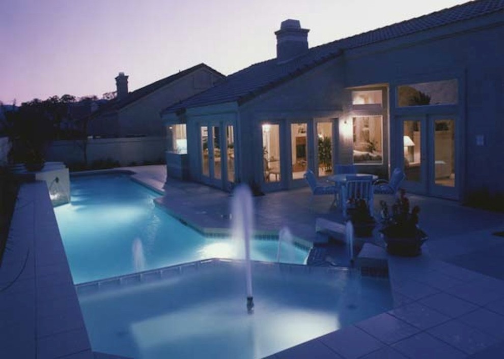 Mid-sized transitional backyard concrete and rectangular lap pool photo in Austin