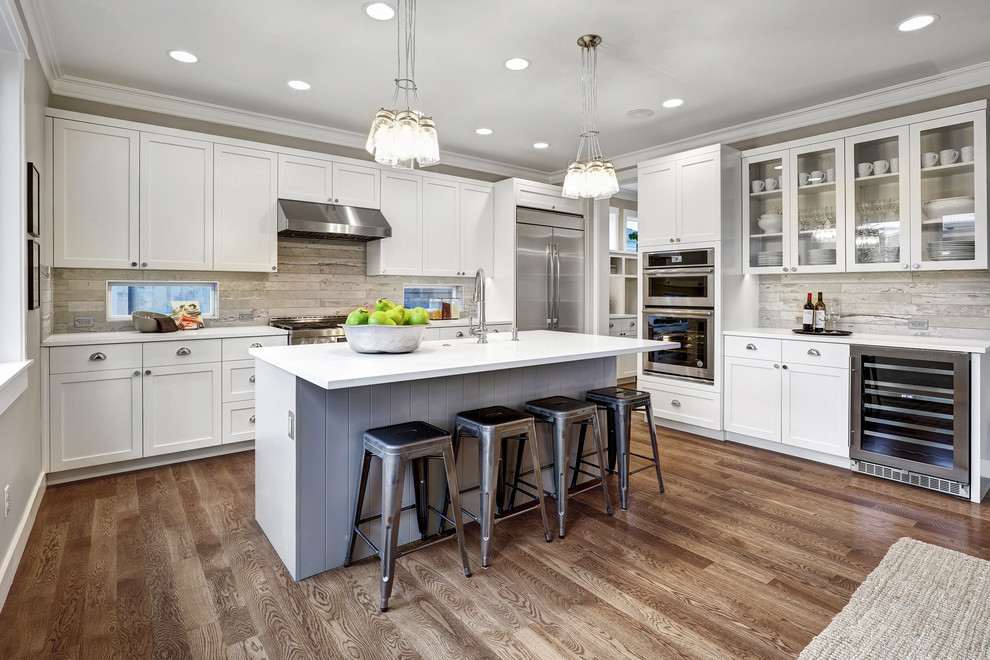 Inspiration for a transitional l-shaped eat-in kitchen in Seattle with shaker cabinets, white cabinets, grey splashback, stainless steel appliances, dark hardwood floors, with island, an undermount sink, quartz benchtops and porcelain splashback.