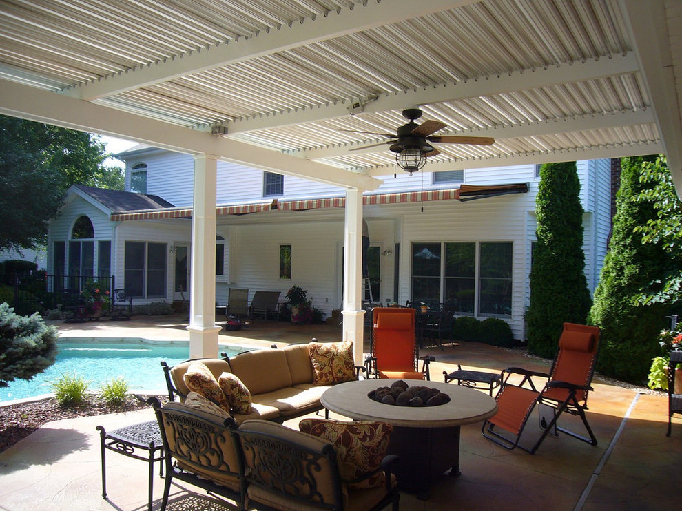 Design ideas for a large traditional backyard patio in Miami with an outdoor kitchen, stamped concrete and a pergola.