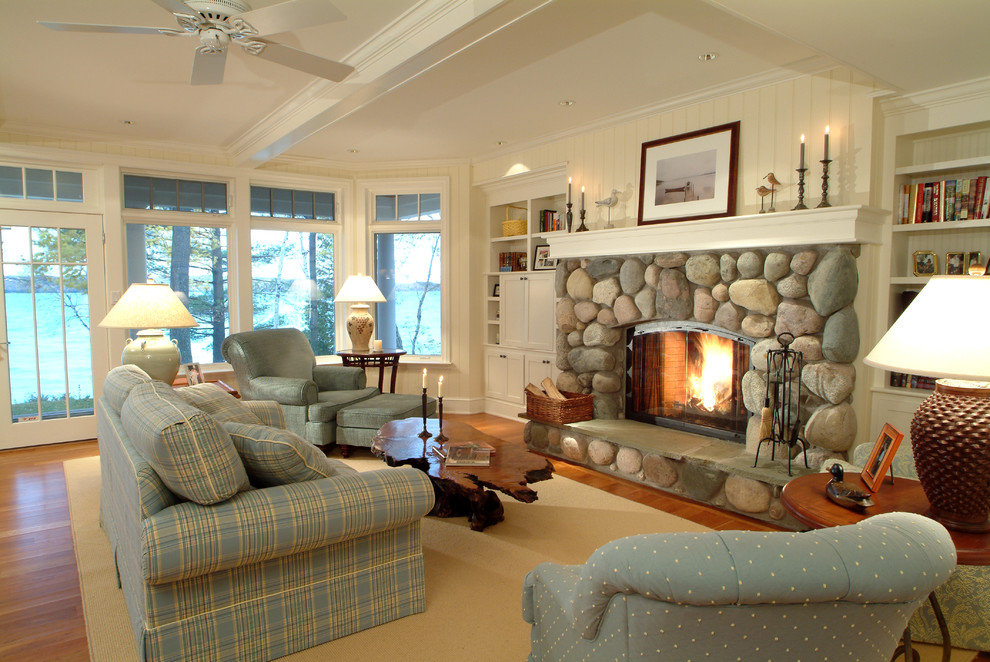 This is an example of a mid-sized arts and crafts formal open concept living room in Other with white walls, medium hardwood floors, a standard fireplace, a stone fireplace surround and brown floor.