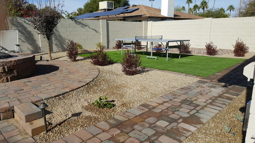 Large traditional backyard garden in Phoenix with concrete pavers.