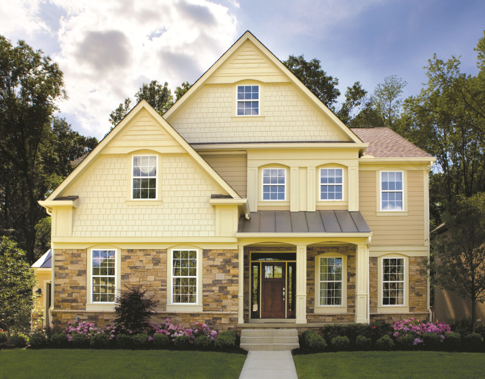 Cottage beige three-story mixed siding exterior home idea