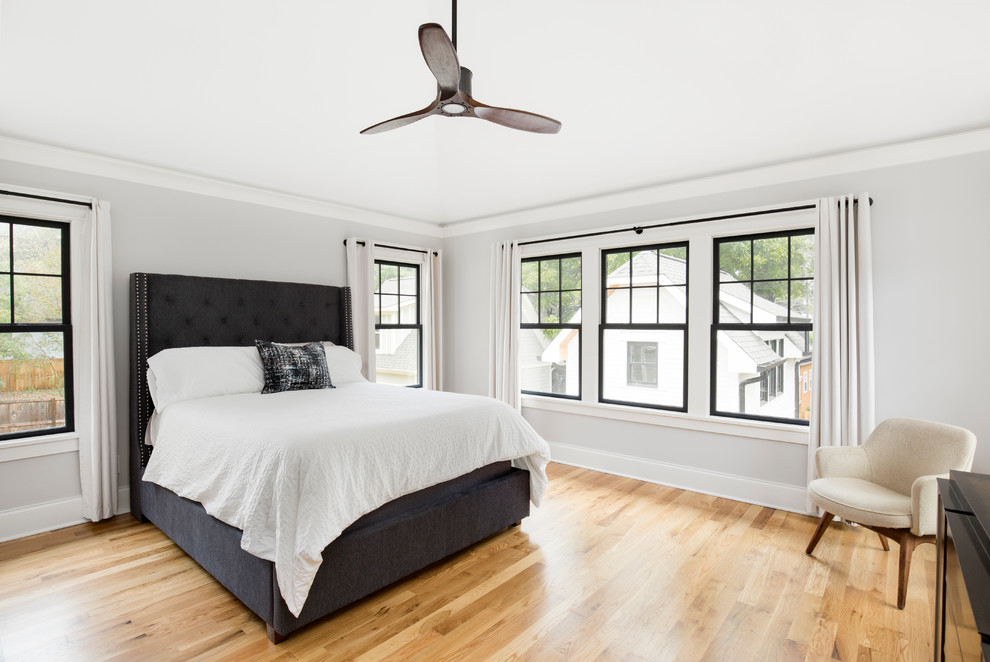 Mid-sized transitional master bedroom in Charlotte with grey walls and light hardwood floors.