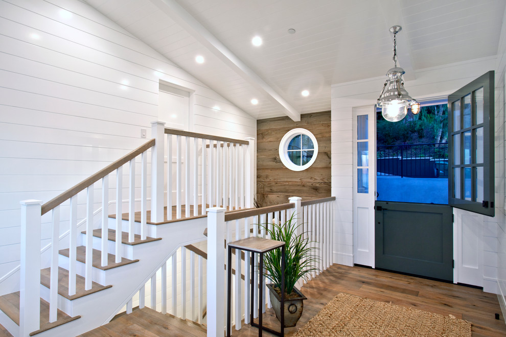 Mid-sized beach style foyer in Orange County with white walls, light hardwood floors, a double front door and a green front door.