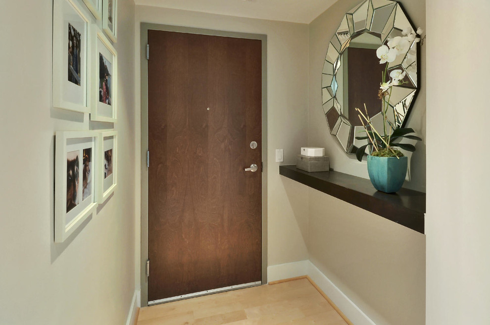 Inspiration for a small transitional light wood floor entry hall remodel in Austin with beige walls and a brown front door
