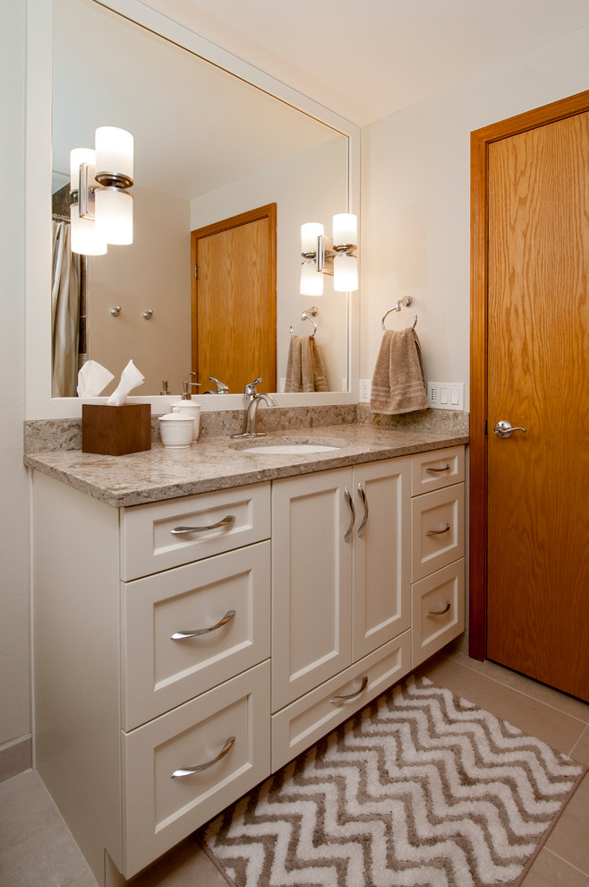 Photo of a transitional bathroom in Boise with an undermount sink, recessed-panel cabinets, white cabinets, engineered quartz benchtops, beige tile, porcelain tile and porcelain floors.