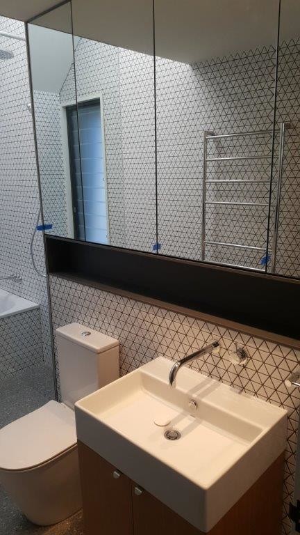 Small contemporary master bathroom in Sydney with flat-panel cabinets, light wood cabinets, an alcove tub, an open shower, a two-piece toilet, white tile, mosaic tile, white walls, an integrated sink, grey floor and an open shower.