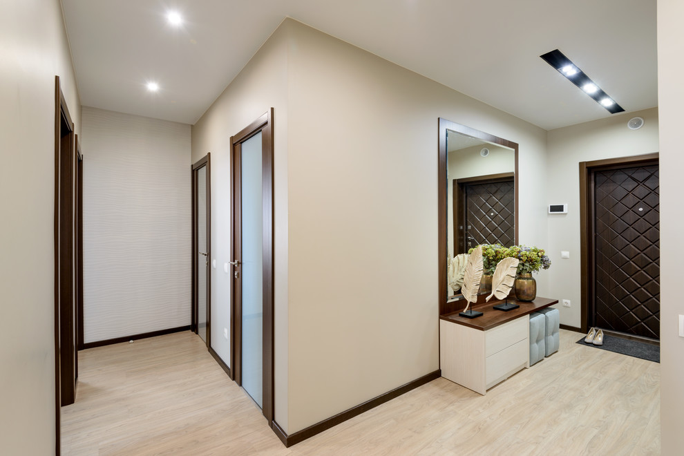 This is an example of a large contemporary hallway in Novosibirsk with beige walls, vinyl floors and beige floor.