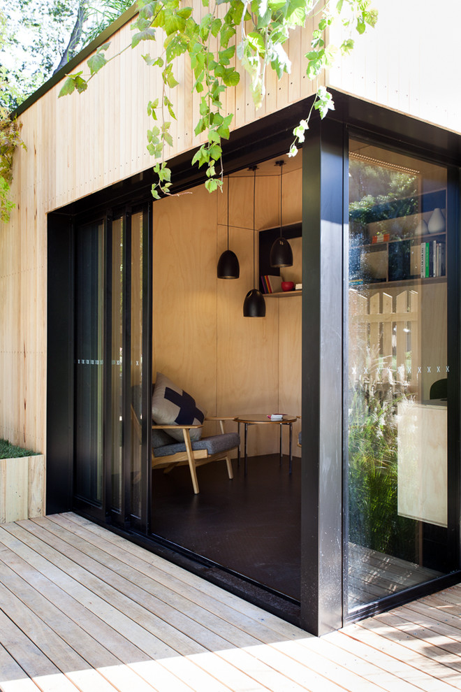 Design ideas for a small contemporary home office in Melbourne with a sliding front door and a black front door.