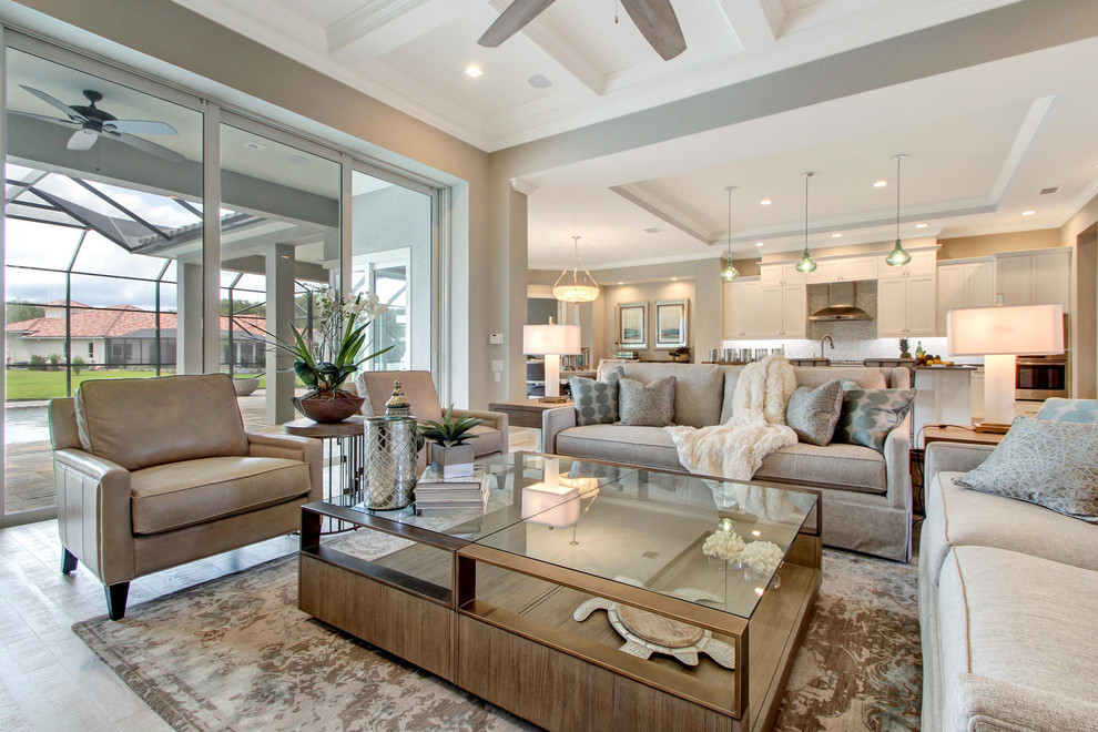 Design ideas for a large transitional formal open concept living room in Orlando with grey walls, light hardwood floors, a standard fireplace and no tv.