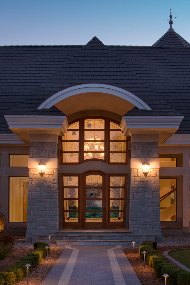 Photo of a beach style front door in Detroit with a glass front door.