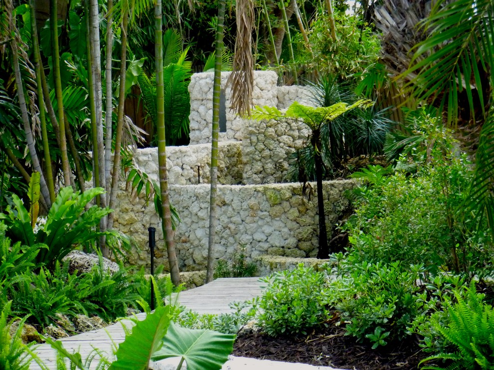 This is an example of a tropical backyard shaded garden in Miami.