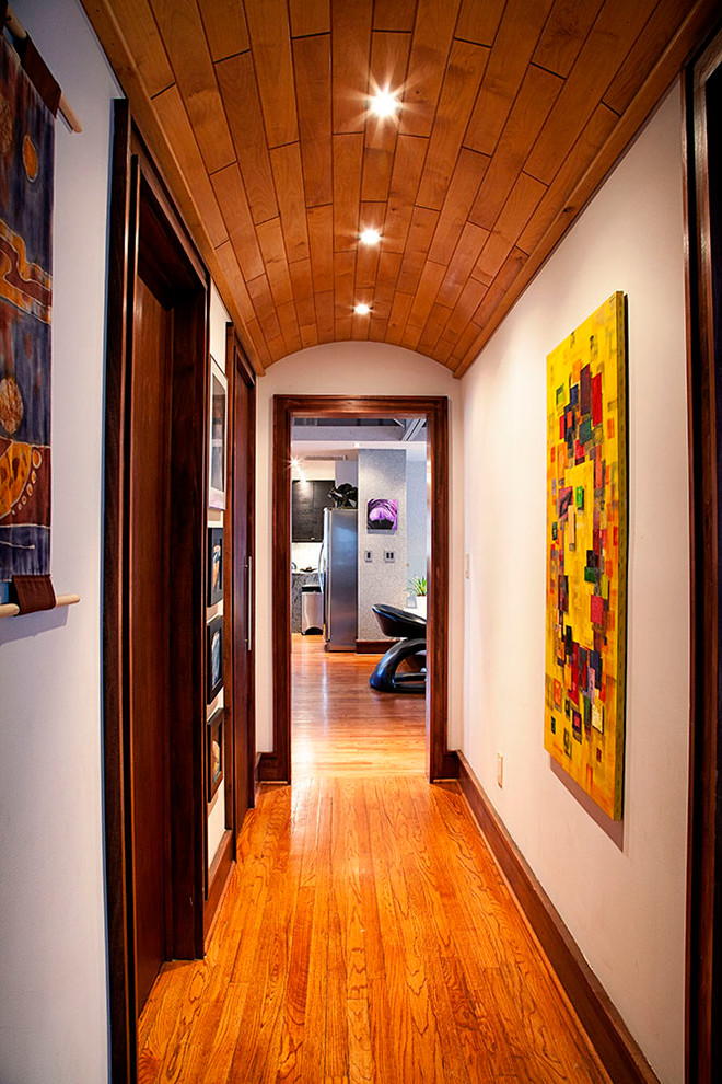 Inspiration for a small modern hallway in Atlanta with beige walls and medium hardwood floors.