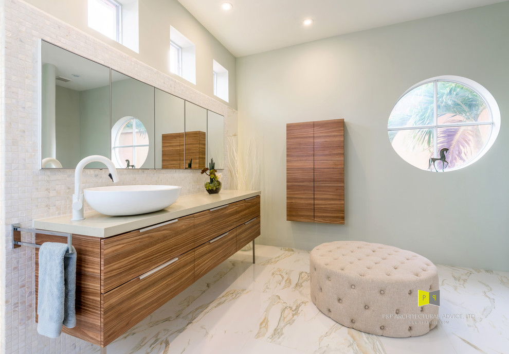 This is an example of a large contemporary bathroom in Miami with a curbless shower, a two-piece toilet, mosaic tile, green walls, porcelain floors, a vessel sink and quartzite benchtops.