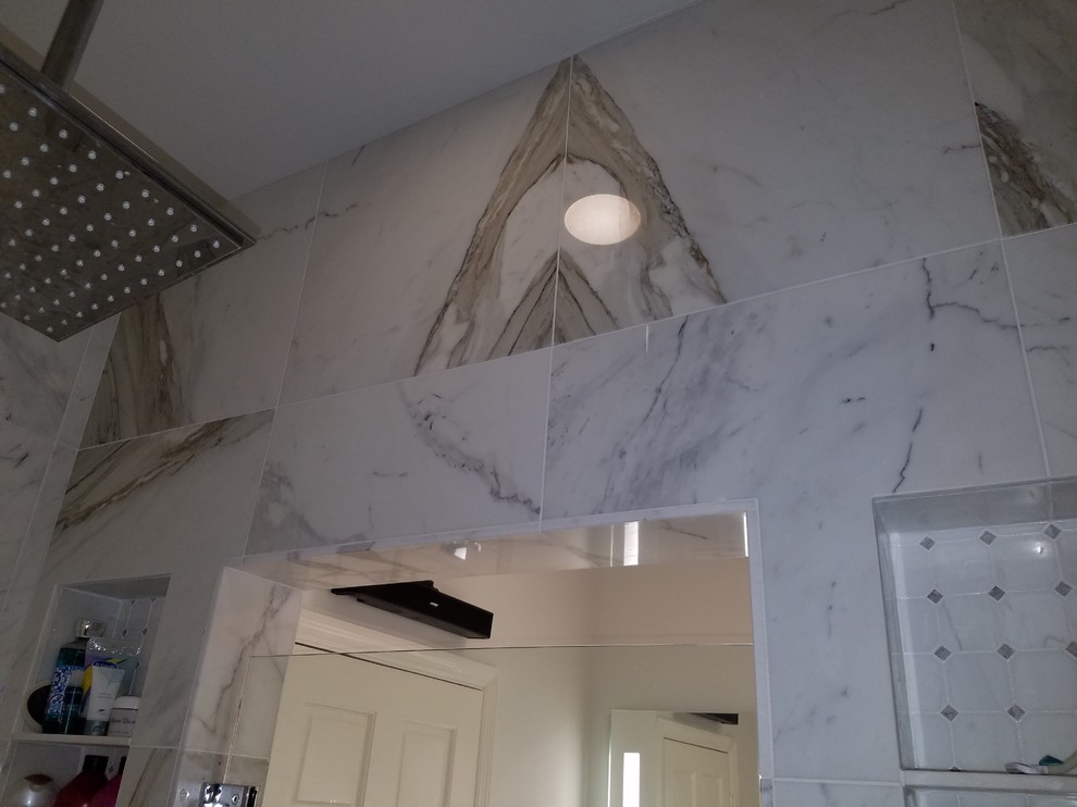 Inspiration for a small transitional master white tile and marble tile marble floor and white floor double shower remodel in Miami with flat-panel cabinets, white cabinets, a one-piece toilet, blue walls, an undermount sink, quartz countertops and a hinged shower door