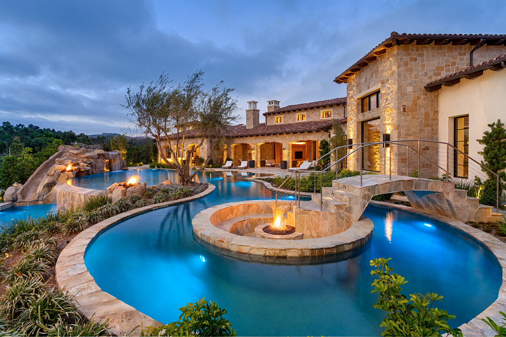 Photo of a mediterranean custom-shaped pool in San Diego with a water slide.