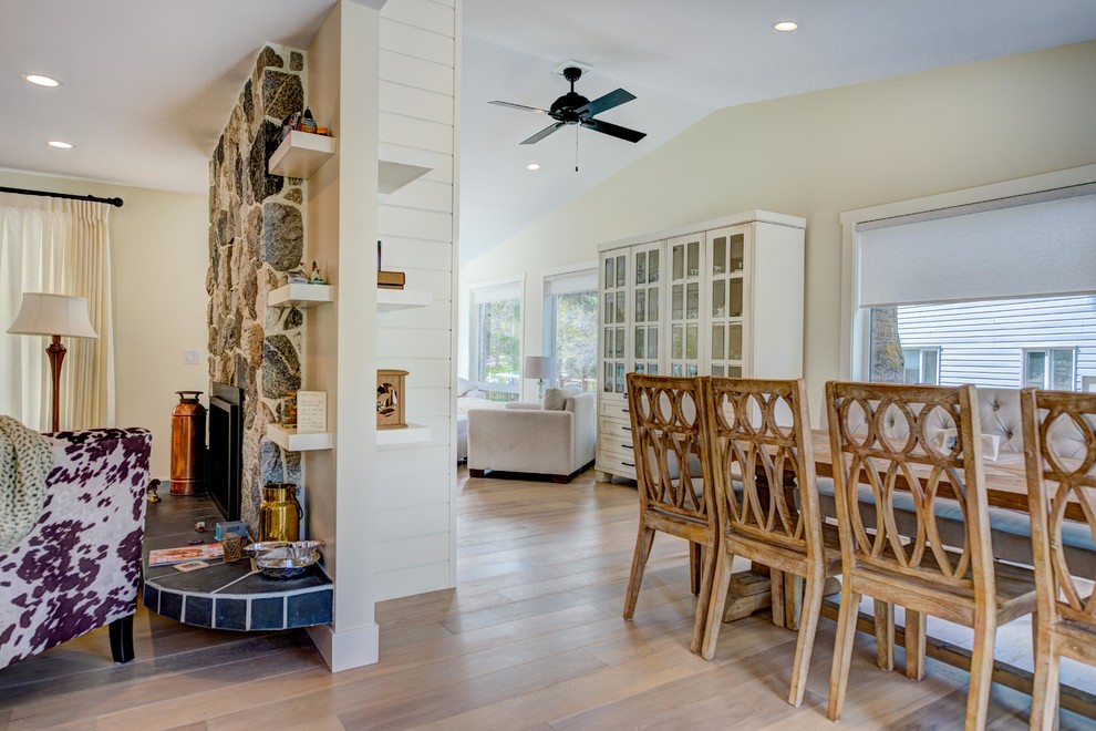 Example of a mid-sized transitional l-shaped medium tone wood floor and beige floor eat-in kitchen design in Vancouver with an undermount sink, shaker cabinets, white cabinets, quartz countertops, white backsplash, ceramic backsplash, stainless steel appliances and an island